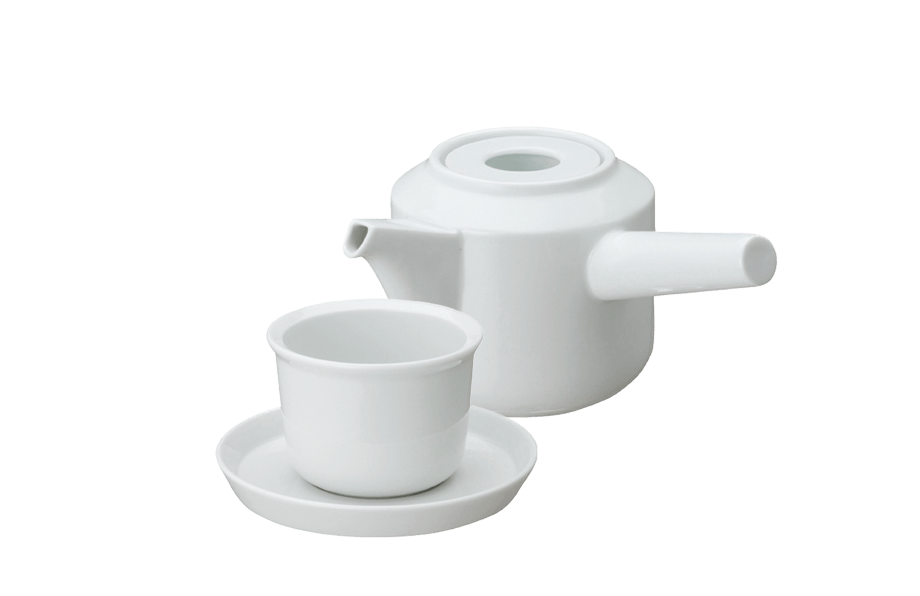 White ceramic teapot with matching teacup and saucer