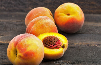 Peaches on a wooden surface