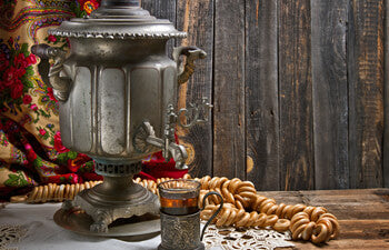 Vintage samovar with tea and bread on a wooden table
