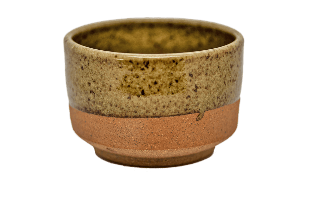 Ceramic matcha bowl with speckled glaze and raw bottom
