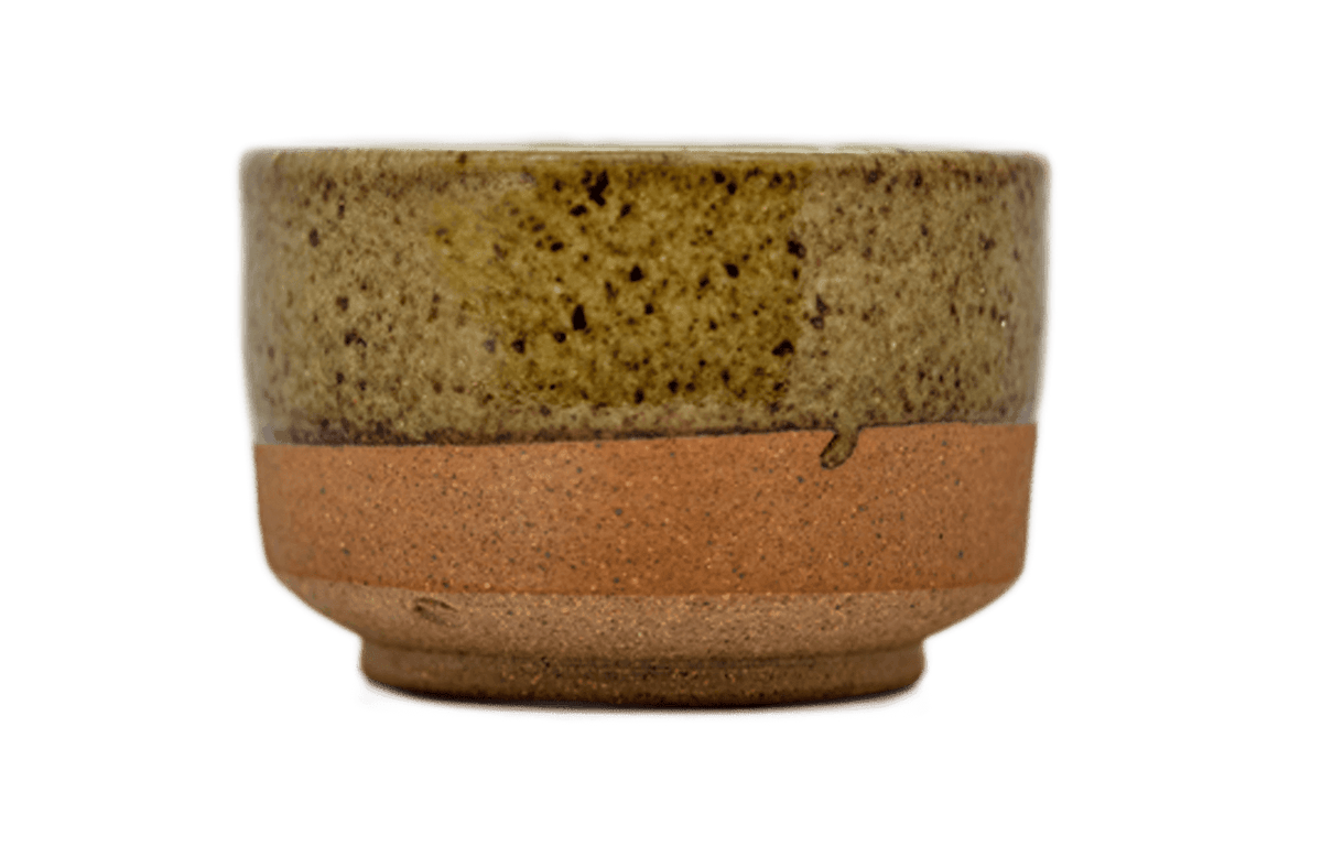 Ceramic matcha bowl with speckled glaze and raw bottom