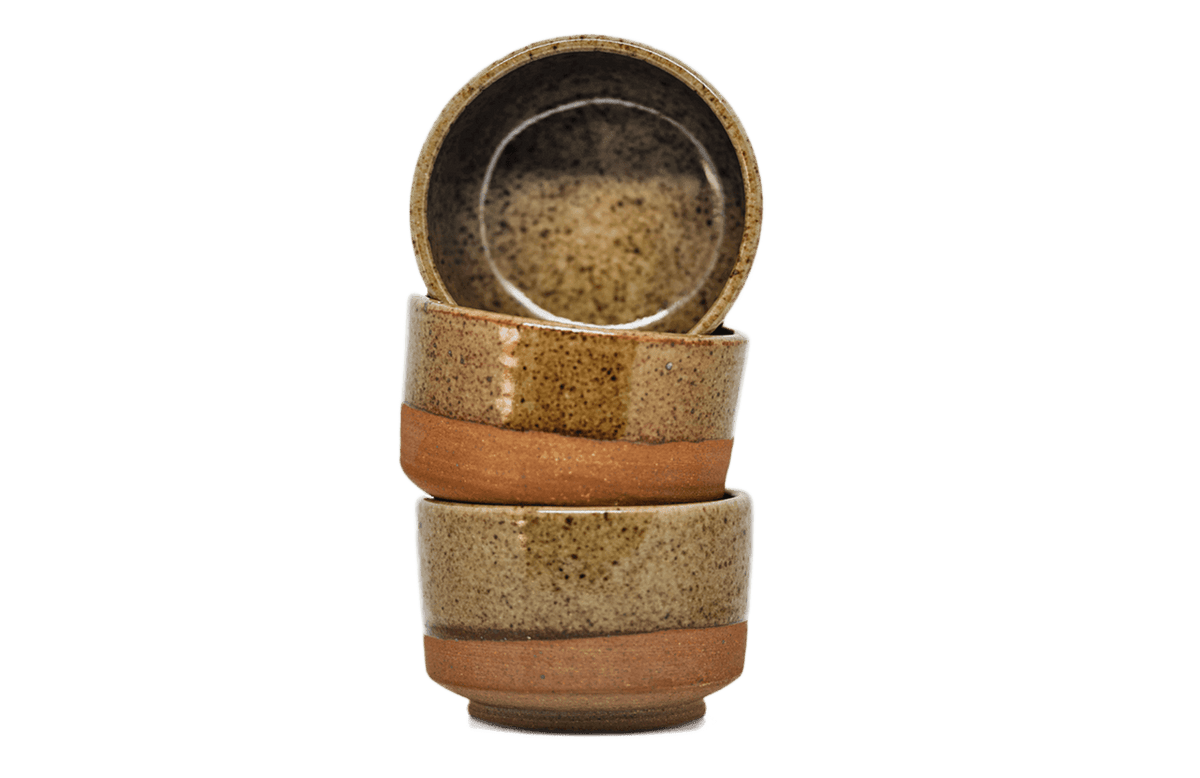 Stack of three ceramic bowls with brown and beige glaze