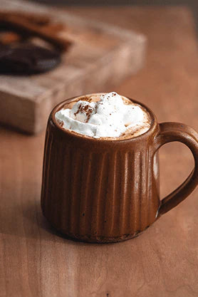 Brown mug filled with Mexican Chaga Chicory and whipped cream