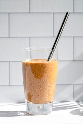 Chaga Chicory Smoothie in a glass with straw