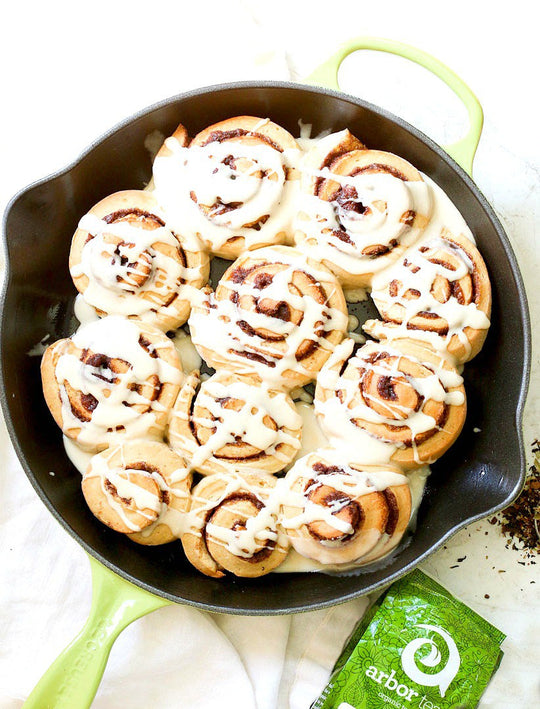 Skillet of Cinnamon Rolls with drizzled glaze