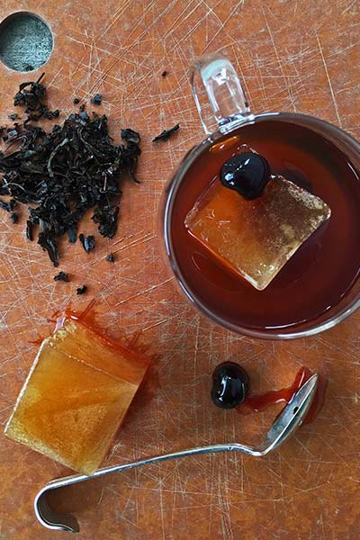Glass of Smoky Tea Infused Manhattan with ice cube