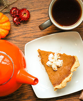A slice of Masala Chai Pumpkin Pie with Teapot