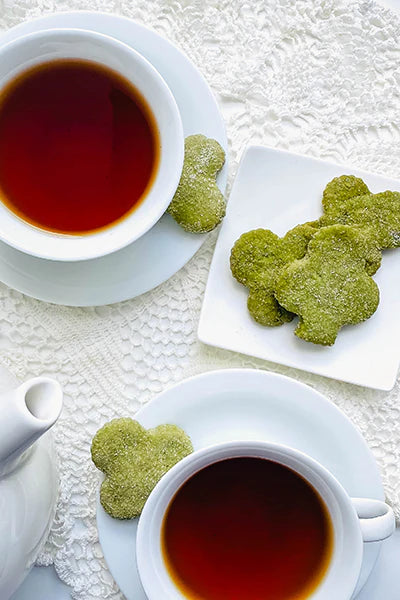 Matcha Sugar Cookies with cups of black tea