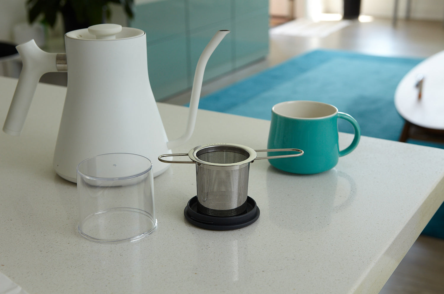 ForLife Travel Infuser sits on a table next to a mug and kettle.