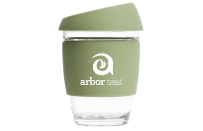 Green reusable coffee cup with 'arbor teas' logo