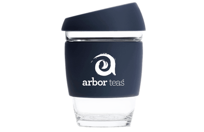 Clear glass tumbler with navy sleeve featuring 'arbor teas' logo 