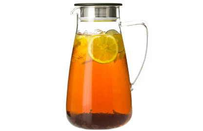 Glass pitcher filled with iced tea and lemon slices