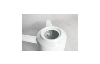 Interior view of white ceramic teapot with built-in sieve