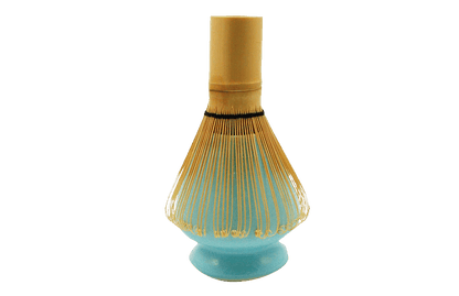 Bamboo whisk on a turquoise ceramic matcha stand