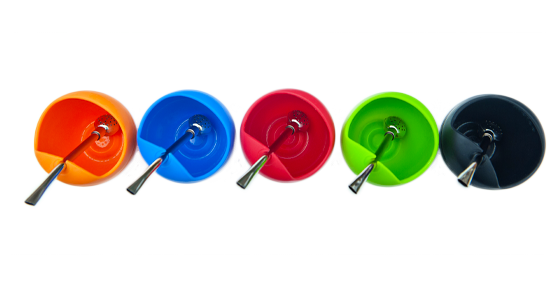 Overhead view of five colorful silicon gourds with metal bombillas