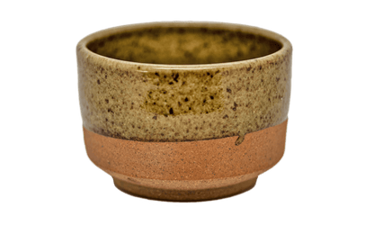 Ceramic matcha bowl with speckled glaze and raw bottom