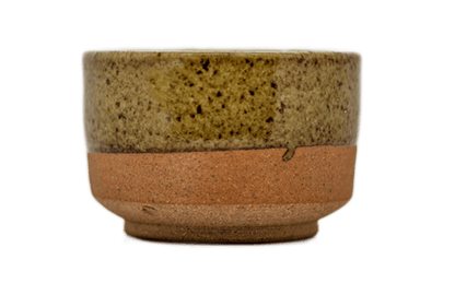 Ceramic matcha bowl with speckled glaze and raw bottom