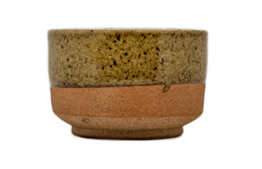 Ceramic matcha bowl with speckled glaze and raw bottom